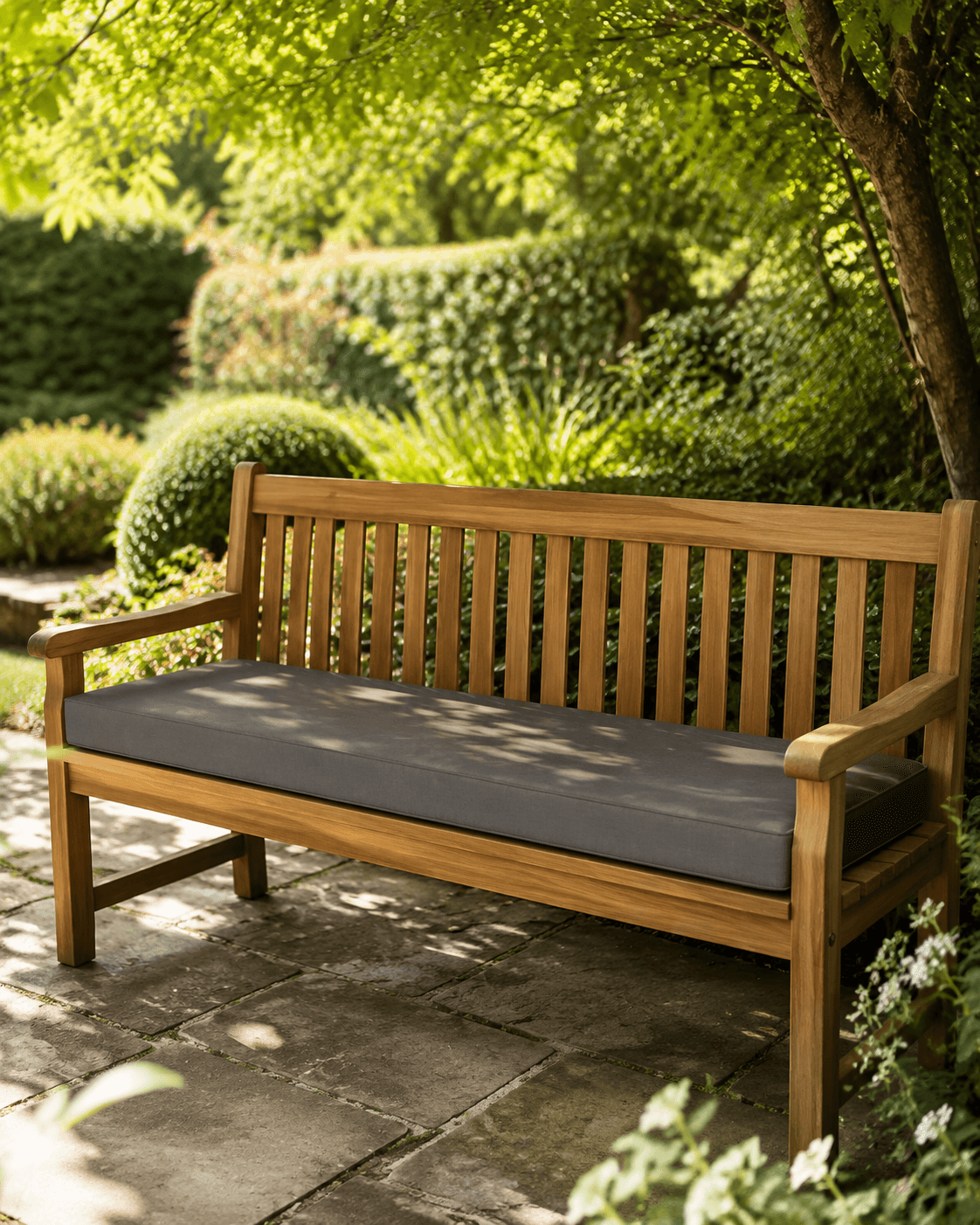 Slate long bench cushion on a wooden garden bench under trees